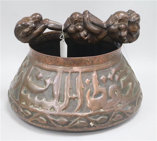 An Isnik copper pot and a hardwood carving